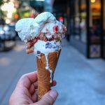 Caffe Bianco Stracciatella and Red Flag with panna on a housebaked cone ($7.50)